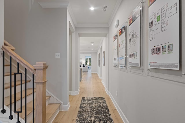 corridor with baseboards, visible vents, stairway, crown molding, and light wood-style floors