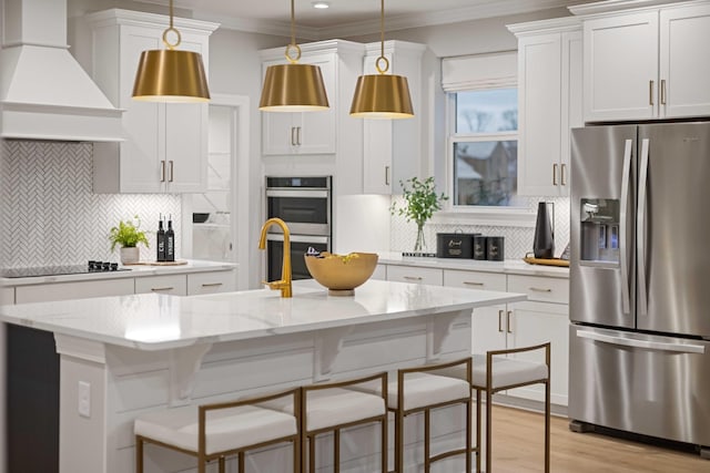 kitchen featuring white cabinets, hanging light fixtures, custom exhaust hood, stainless steel appliances, and crown molding