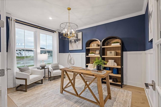 home office with crown molding, wainscoting, an inviting chandelier, and light wood-style floors