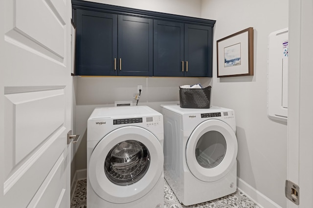 laundry area featuring cabinet space, independent washer and dryer, and baseboards