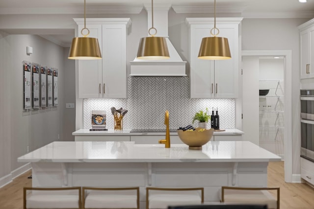 kitchen with crown molding, decorative backsplash, black electric cooktop, and decorative light fixtures