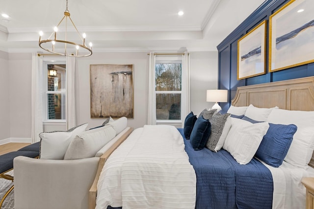 bedroom with baseboards, a raised ceiling, crown molding, and wood finished floors