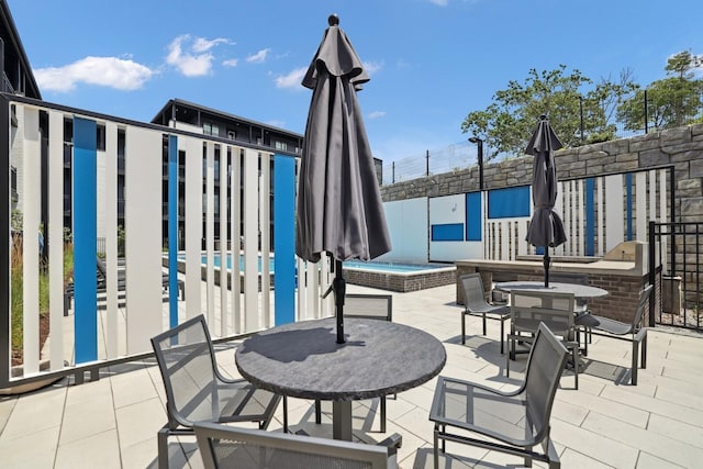 view of patio / terrace featuring a jacuzzi and outdoor dining area