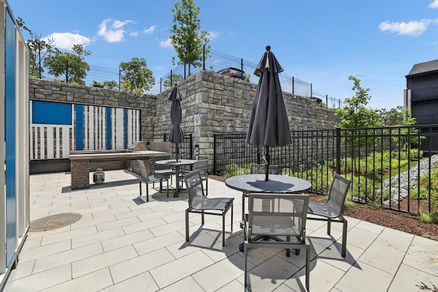 view of patio / terrace featuring outdoor dining space and fence