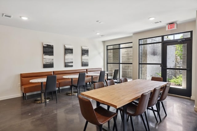 dining room with finished concrete floors, recessed lighting, visible vents, and baseboards