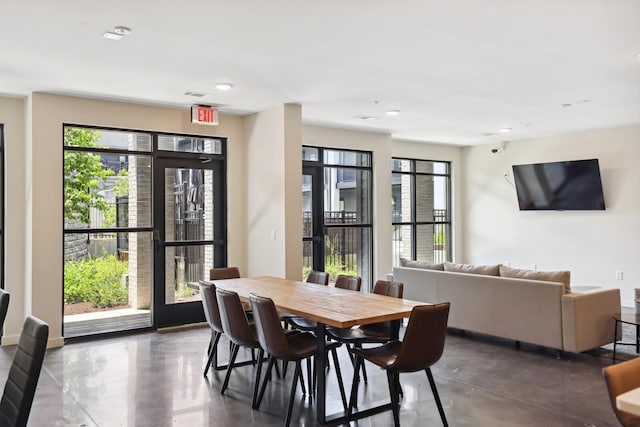 dining space with finished concrete flooring and visible vents