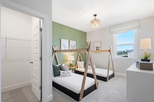 bedroom featuring light colored carpet and baseboards