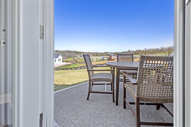 balcony with outdoor dining area and a patio area