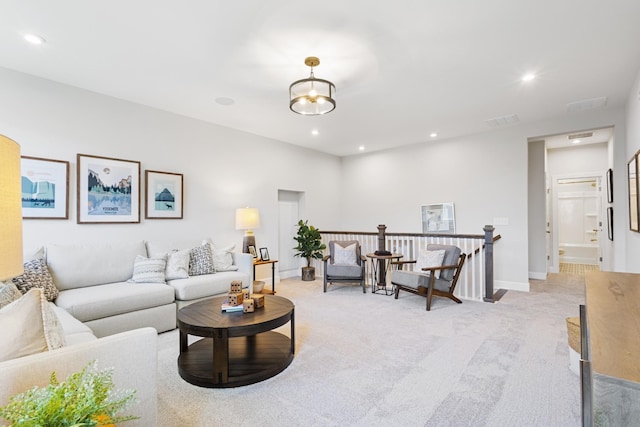 living room with light carpet, visible vents, baseboards, and recessed lighting