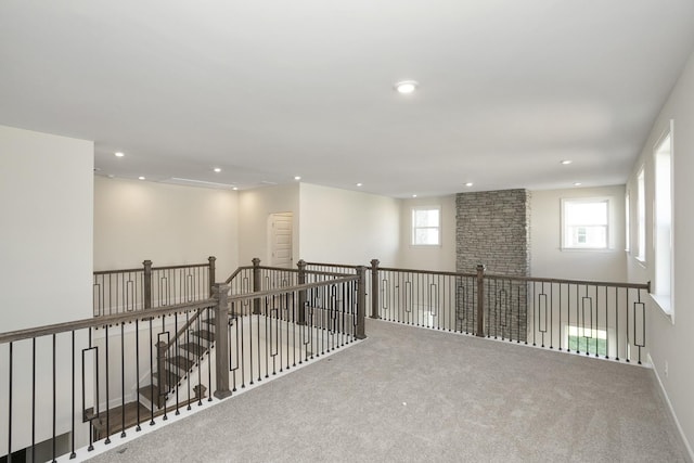 spare room featuring recessed lighting, carpet flooring, and baseboards