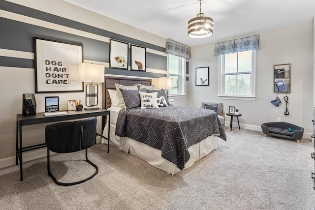 carpeted bedroom featuring baseboards