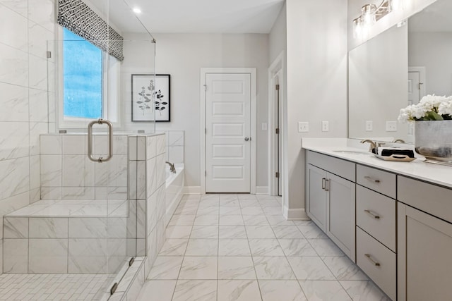 full bath featuring marble finish floor, a garden tub, vanity, and a shower stall