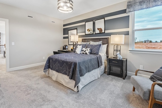 bedroom with carpet, visible vents, and baseboards