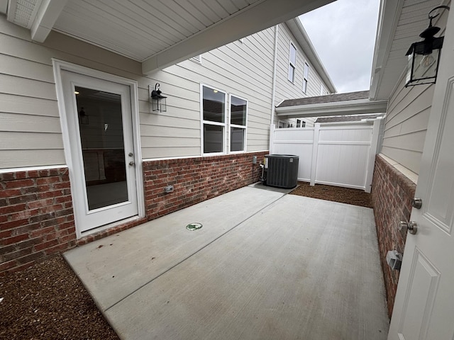 view of patio / terrace with cooling unit and fence