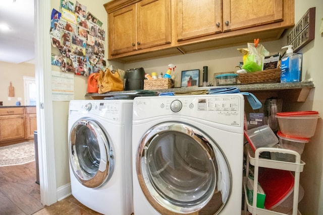 laundry area with cabinet space, tile patterned flooring, and washer and clothes dryer