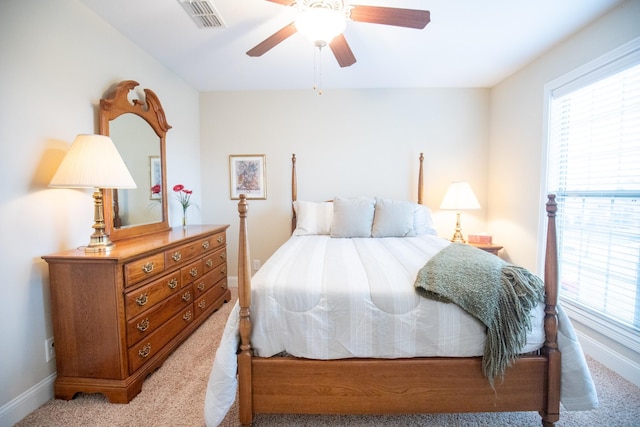 bedroom featuring light carpet, visible vents, and baseboards