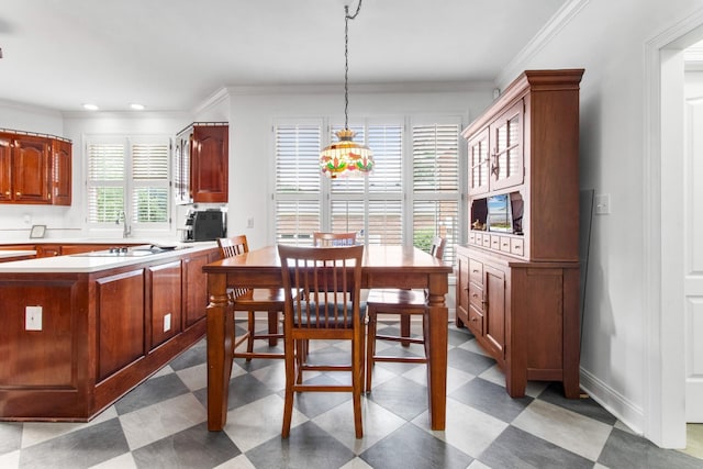 dining room with crown molding, baseboards, and tile patterned floors