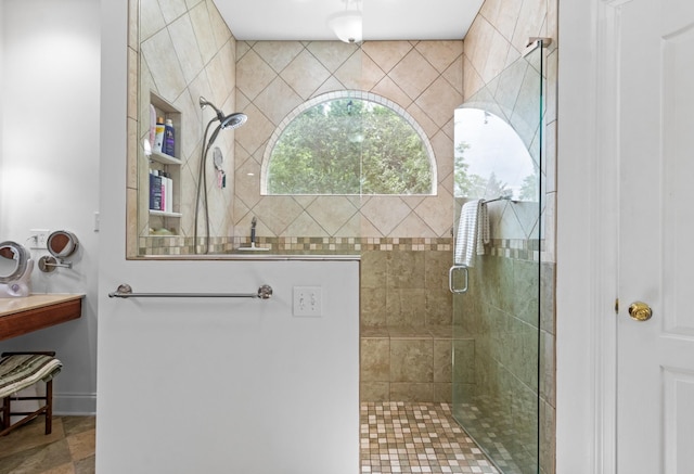 bathroom with a tile shower