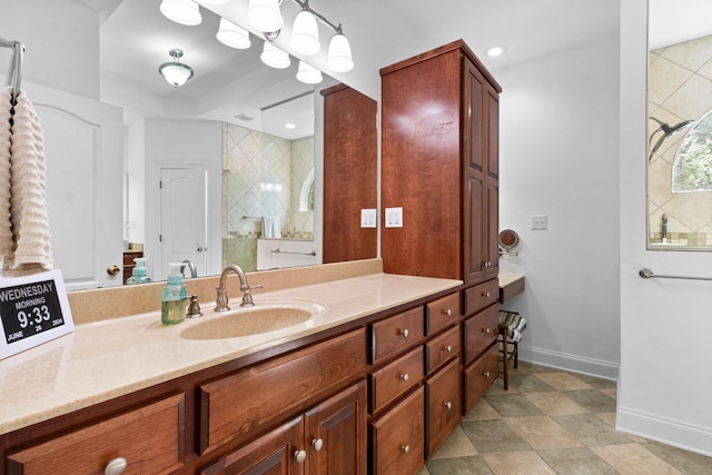 bathroom featuring recessed lighting, tiled shower, vanity, and baseboards