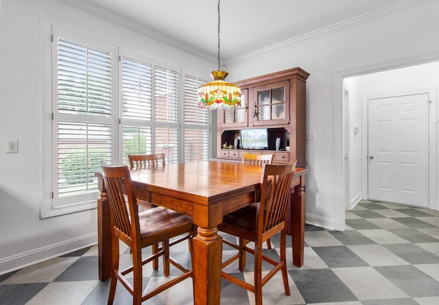 dining area featuring dark floors, baseboards, and crown molding