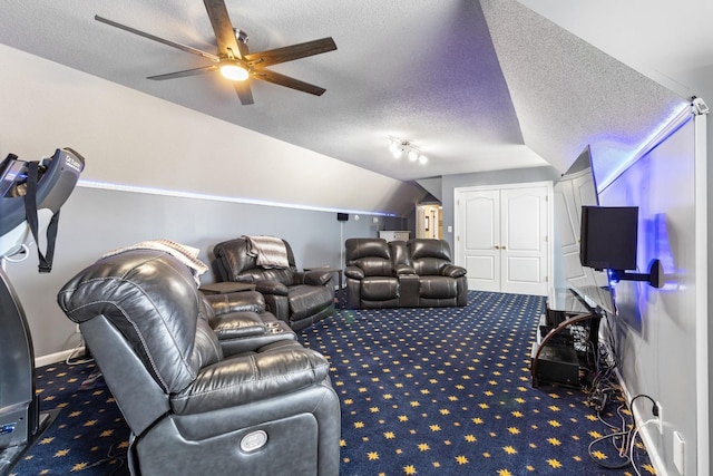 cinema room featuring carpet flooring, vaulted ceiling, a textured ceiling, and ceiling fan