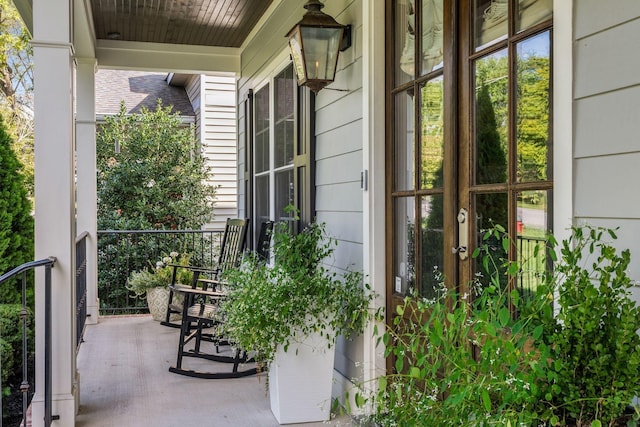 balcony with covered porch and french doors