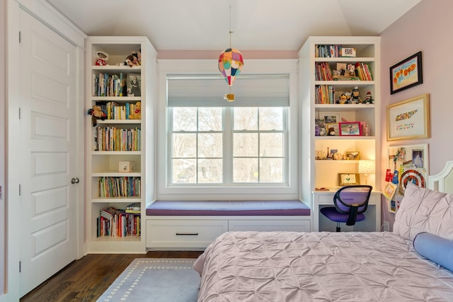 bedroom with dark wood-type flooring and built in study area