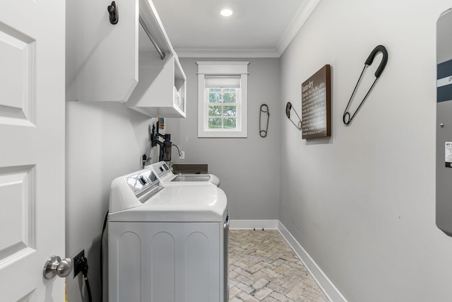 laundry area with brick floor, ornamental molding, washing machine and dryer, laundry area, and baseboards