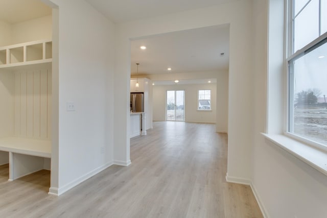 mudroom with recessed lighting, baseboards, and light wood finished floors