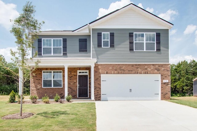 view of front facade featuring an attached garage, driveway, brick siding, and a front yard