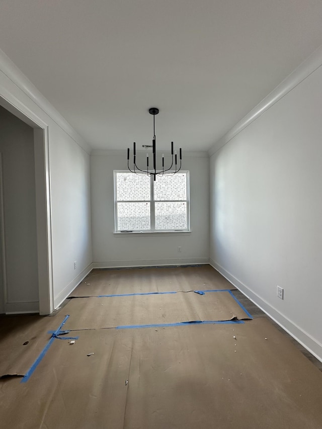 unfurnished dining area featuring baseboards, an inviting chandelier, and crown molding