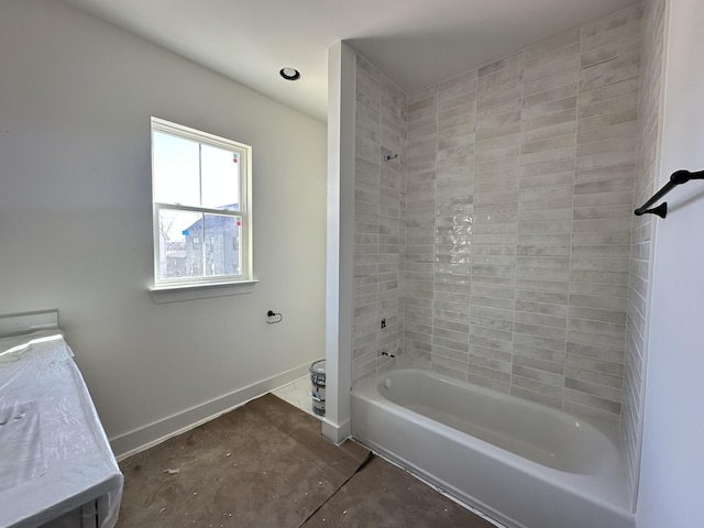 bathroom with baseboards and shower / bathing tub combination