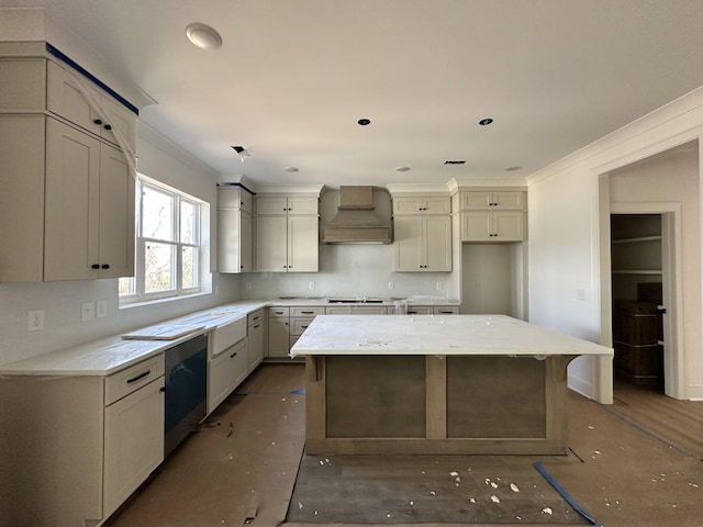 kitchen featuring gas cooktop, light stone countertops, stainless steel dishwasher, a center island, and custom range hood