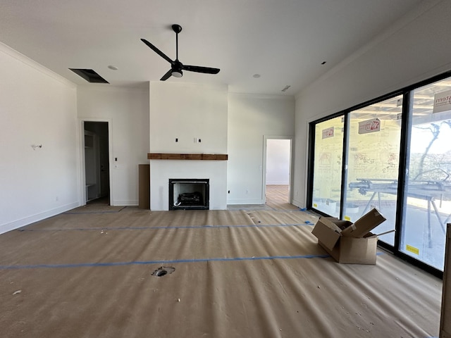 unfurnished living room with a fireplace, wood finished floors, a ceiling fan, baseboards, and crown molding