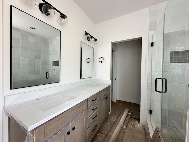 full bath with a stall shower and double vanity