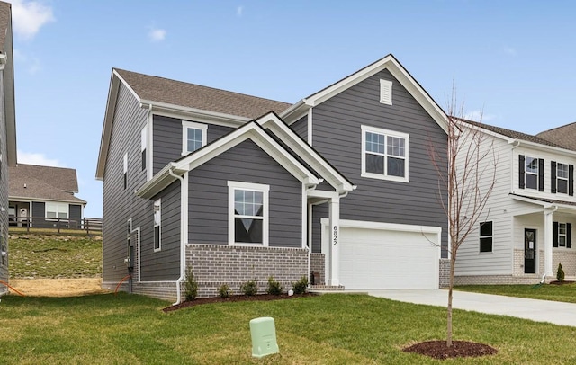 view of front of house featuring a front yard, concrete driveway, brick siding, and an attached garage