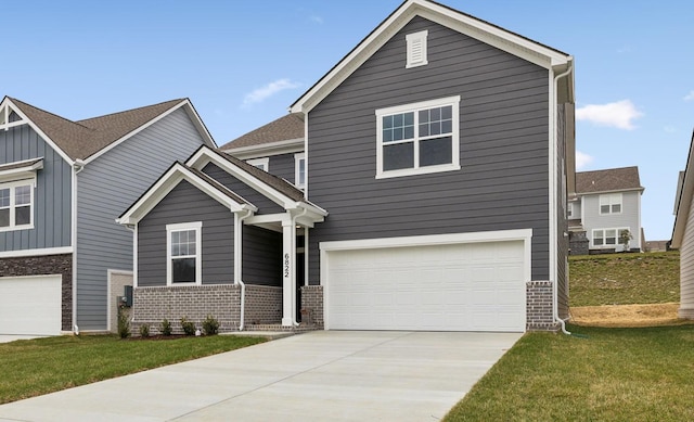 view of front of house featuring an attached garage, driveway, a front yard, and brick siding