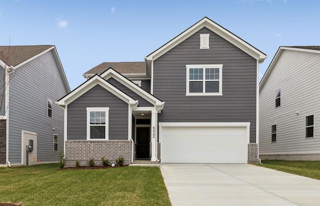 view of front facade with a front yard, concrete driveway, brick siding, and an attached garage