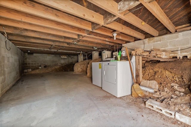 unfinished basement featuring independent washer and dryer