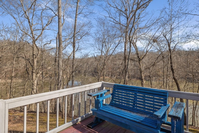 wooden terrace with a view of trees