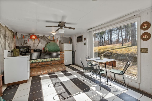 sunroom with plenty of natural light and ceiling fan