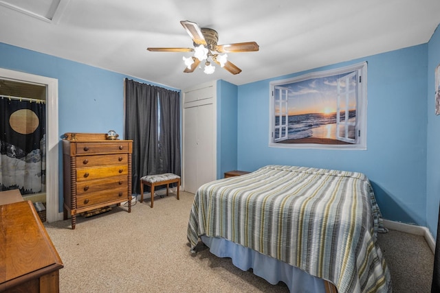 bedroom with light colored carpet, a ceiling fan, baseboards, a closet, and attic access