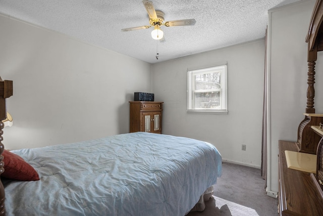 bedroom featuring carpet flooring, ceiling fan, and a textured ceiling