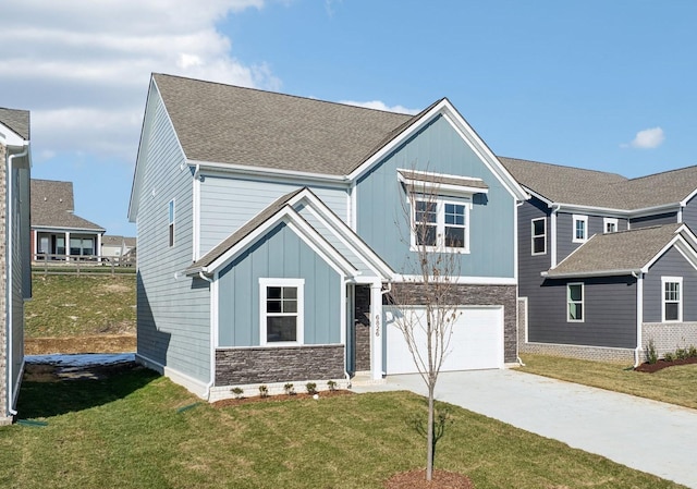 view of front of property with an attached garage, stone siding, concrete driveway, a front lawn, and board and batten siding