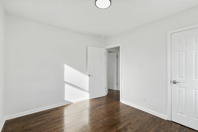 unfurnished room featuring wood finished floors and baseboards