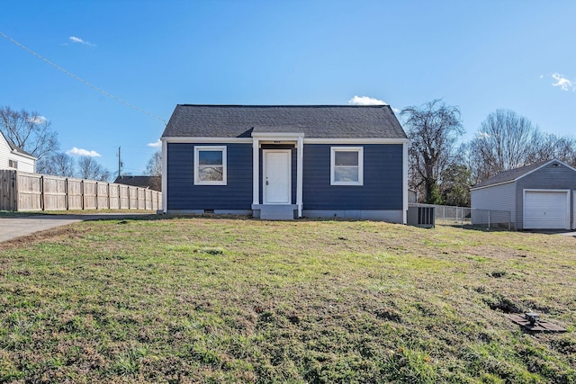 bungalow with crawl space, a detached garage, fence, and a front lawn