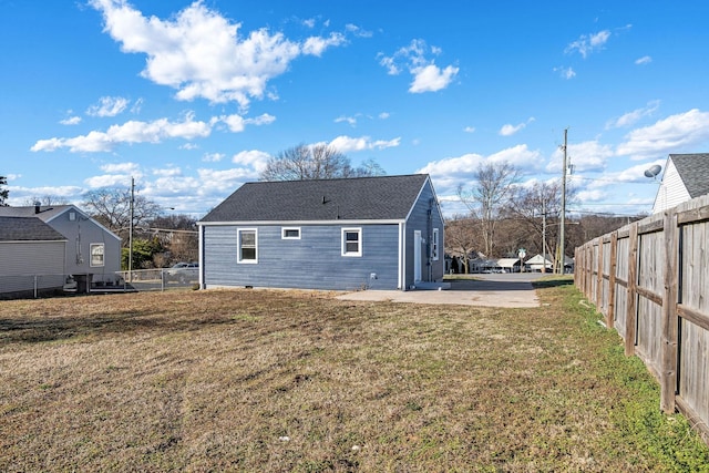 rear view of house with a yard, a patio, and fence