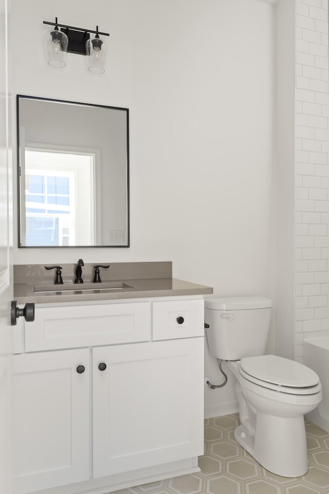 bathroom featuring vanity, toilet, and tile patterned floors