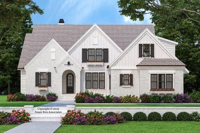 view of front of house with a shingled roof, board and batten siding, and brick siding