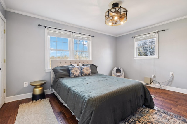 bedroom with multiple windows, baseboards, and wood finished floors